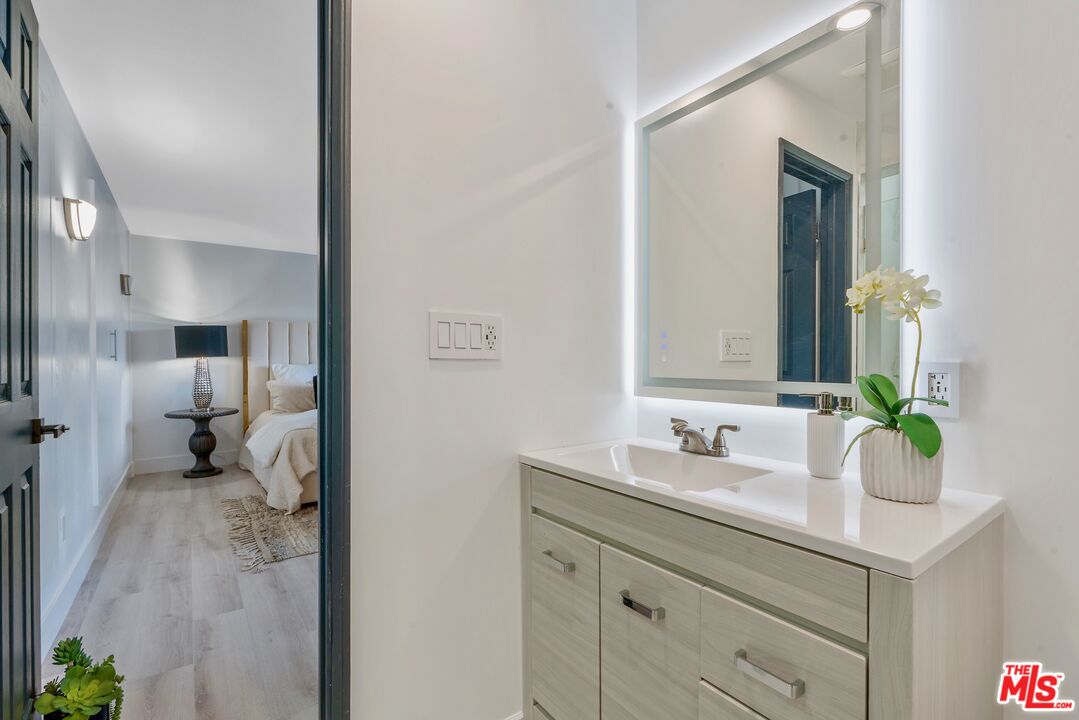 4854 Brewster Drive Tarzana, CA 91356 - Photo 43 of 60 a en suite bathroom with a sink double vanity and a mirror