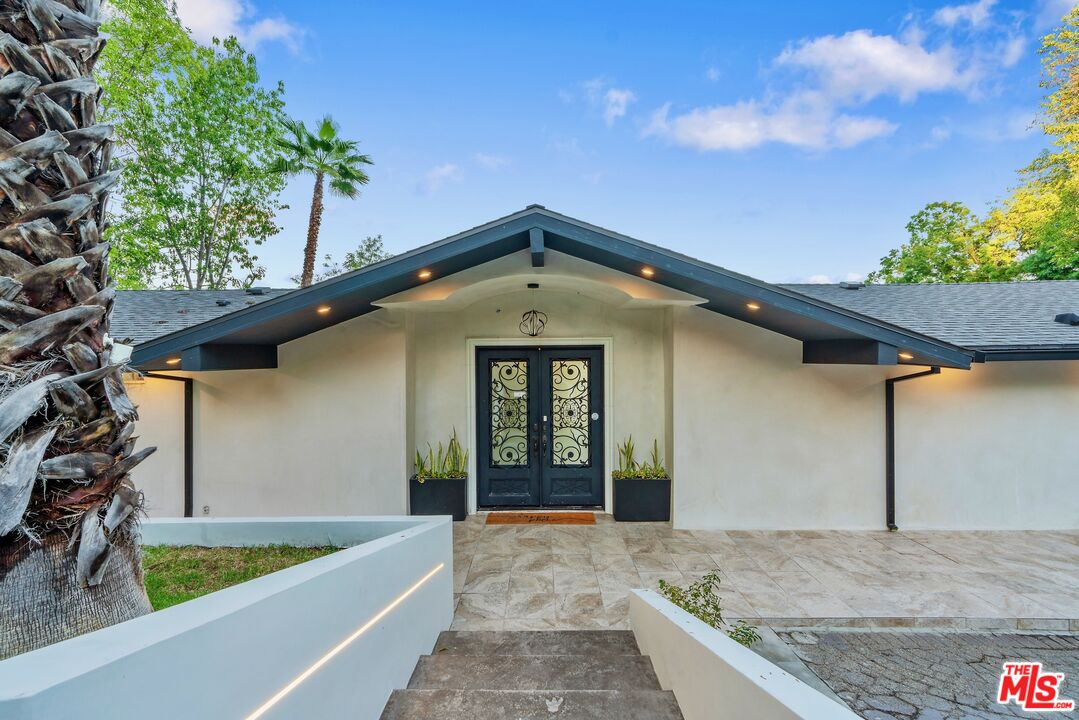 4854 Brewster Drive Tarzana, CA 91356 - Photo 10 of 60 a view of a house with a tub and potted plants