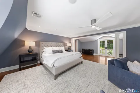 a spacious bedroom with a large bed and a couch