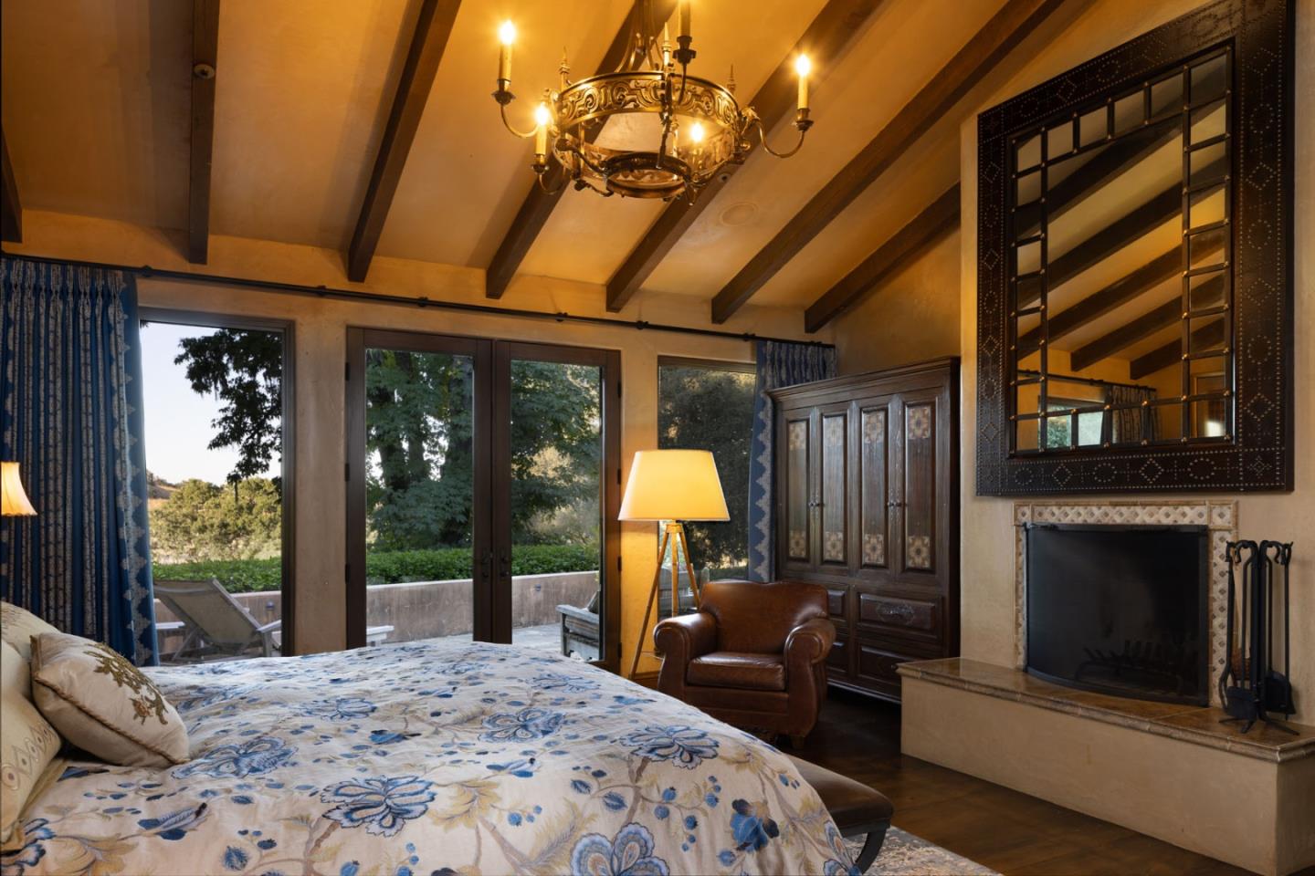 4 Rumsen Trace Carmel, CA 93923 - Photo 11 of 21 a bedroom with bed and a chandelier