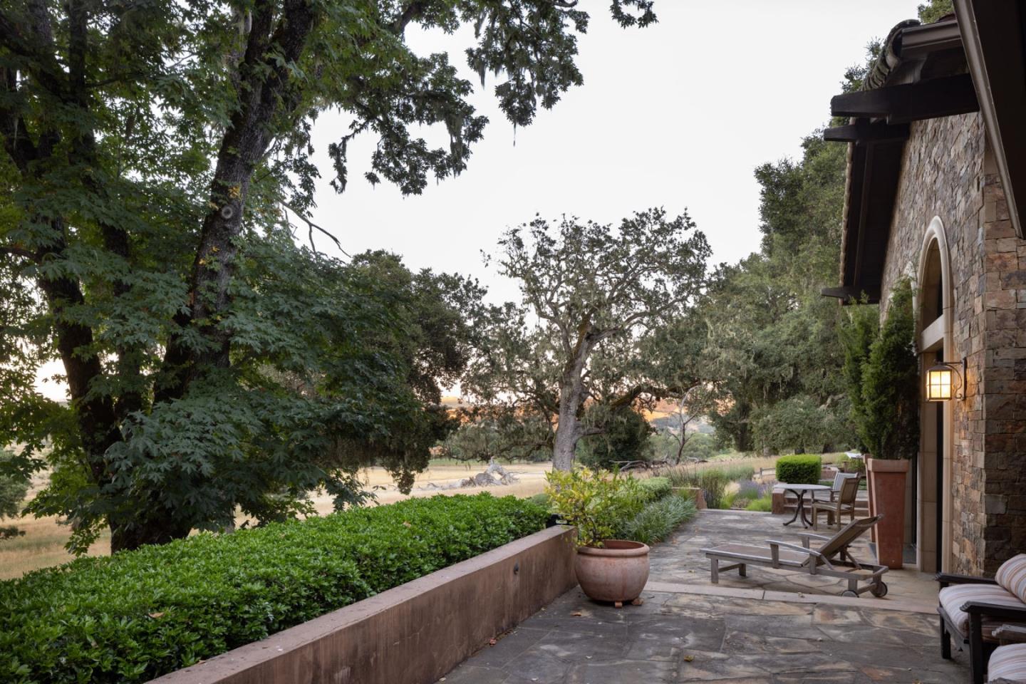 4 Rumsen Trace Carmel, CA 93923 - Photo 18 of 21 a view of a patio with table and chairs and potted plants