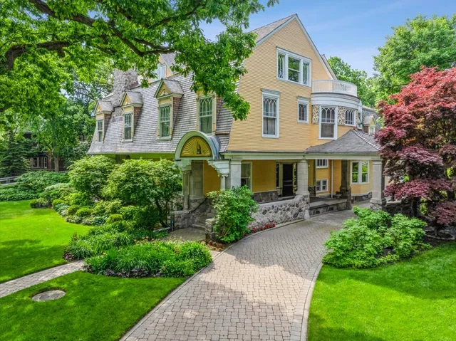 a front view of a house with garden and porch
