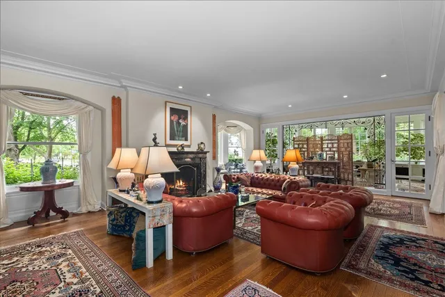 a living room with furniture a fireplace and a chandelier