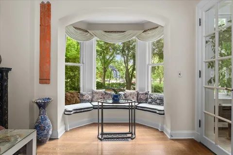 a living room with furniture a chandelier and a fireplace