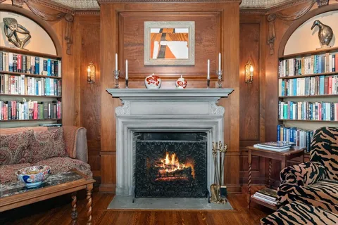 a kitchen with stainless steel appliances granite countertop a refrigerator and a table chair