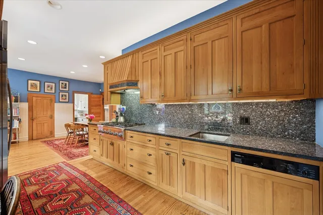 a spacious bedroom with a bed and a chandelier