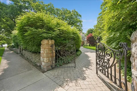 an aerial view of a house with a yard and lake view