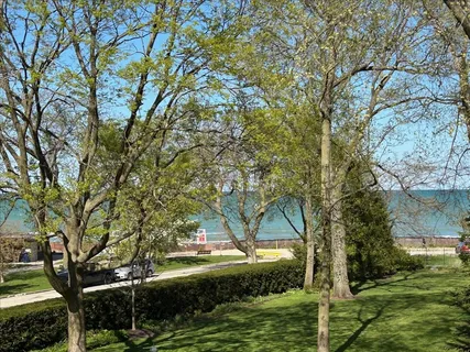 a front view of a residential apartment building with a yard