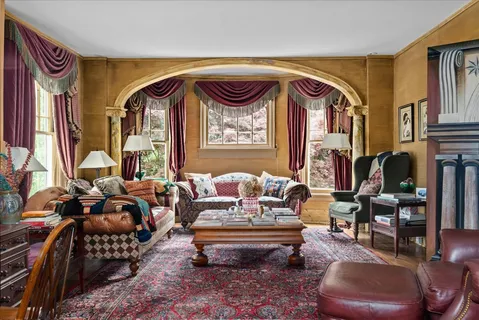a living room with furniture and a flat screen tv with wooden floor