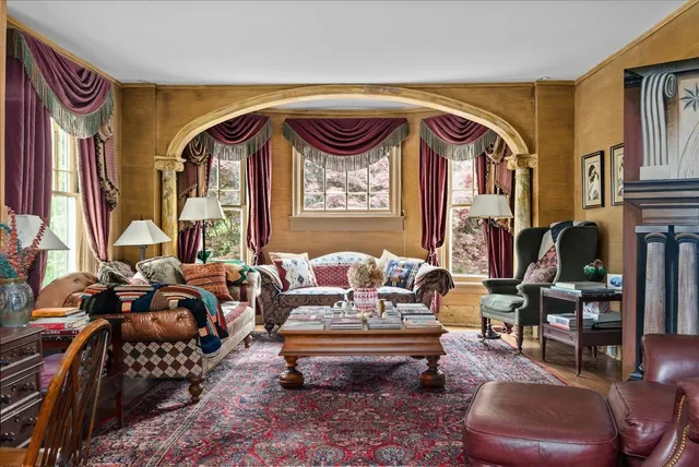 a living room with furniture and a flat screen tv with wooden floor