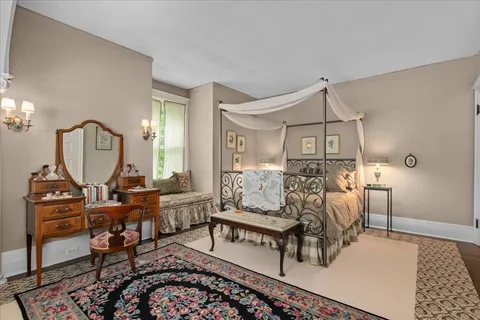 a dining room with furniture a chandelier and wooden floor