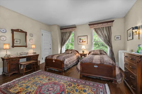 a spacious bedroom with a bed a couch and a window