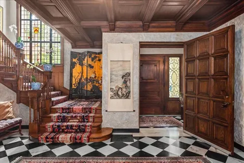 a living room with furniture fireplace and large windows