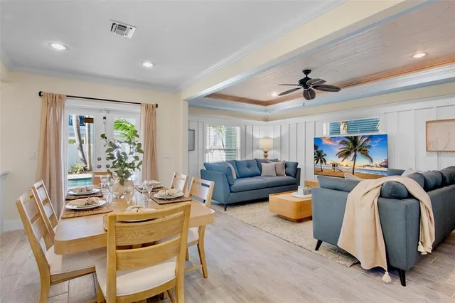 a living room with furniture a ceiling fan and a rug