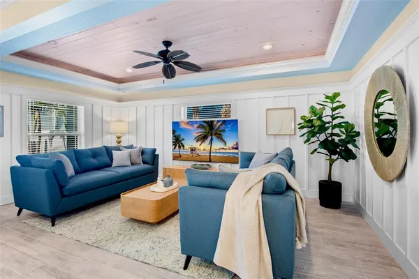 a living room with furniture a chandelier and a window