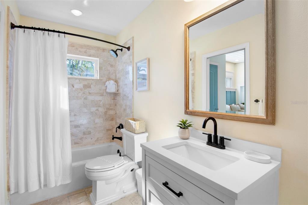 709 Fern Street Anna Maria, FL 34216 - Photo 19 of 35 a bathroom with a sink a toilet and shower