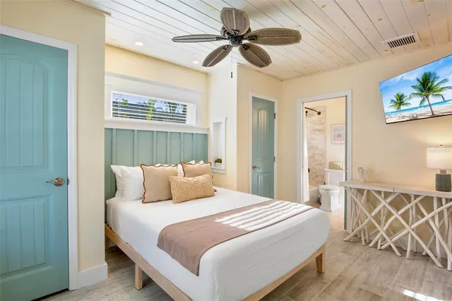 a bedroom with a bed and a chandelier