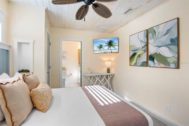 a bedroom with a bed and a painting on the wall