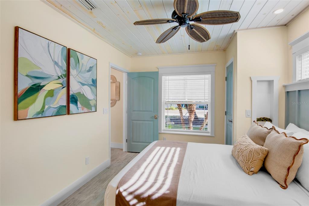 709 Fern Street Anna Maria, FL 34216 - Photo 23 of 35 a bedroom with a bed and a painting on the wall