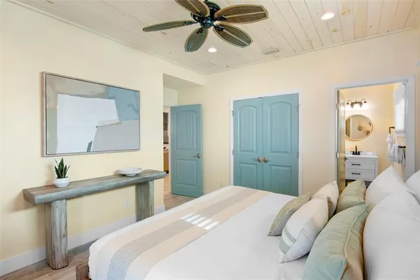 a bedroom with a bed and a chandelier