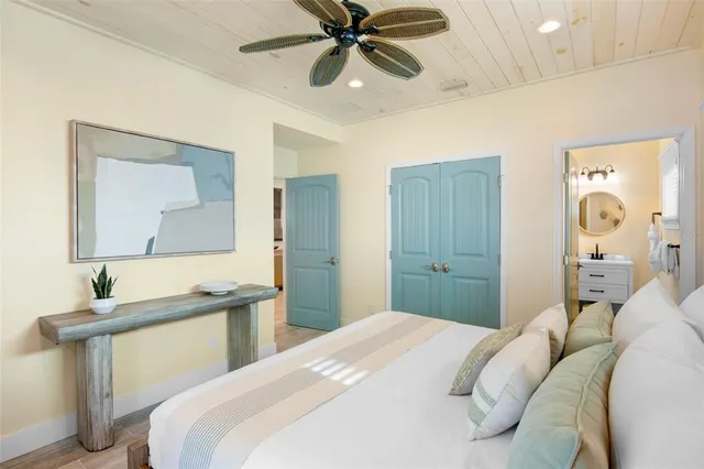 a bedroom with a bed and a chandelier