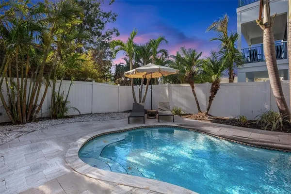 a swimming pool with outdoor seating and yard