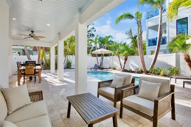 a view of a patio with couches and potted plants