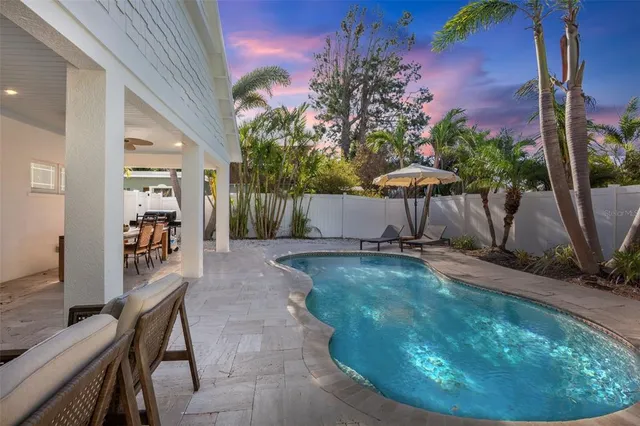 a view of a backyard with plants and outdoor seating