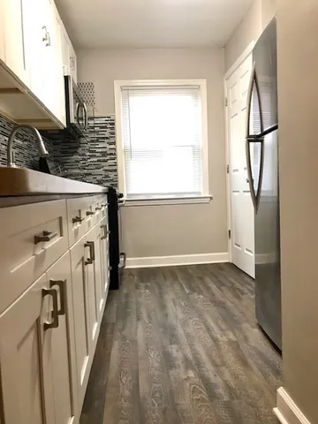 a view of a kitchen with a sink a washer and dryer