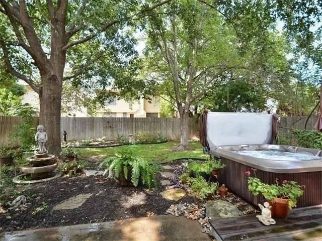 a view of a backyard with plants and a patio