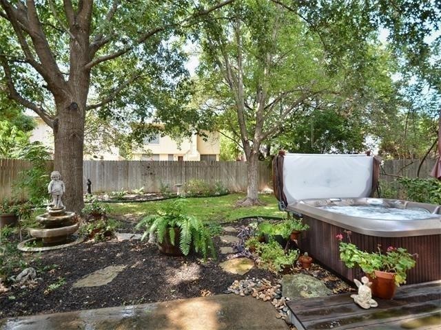 7508 Windrush Drive Austin, TX 78729 - Photo 11 of 22 a view of a backyard with plants and a patio
