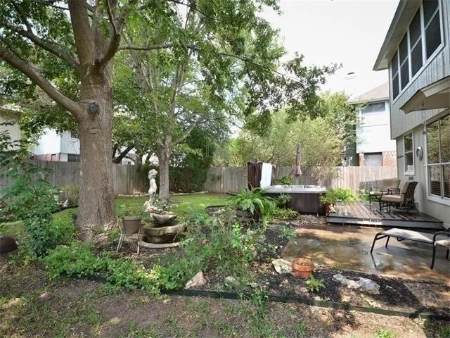 a backyard of a house with table and chairs