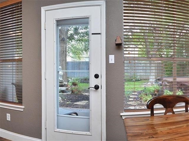 7508 Windrush Drive Austin, TX 78729 - Photo 15 of 22 a view of a balcony with chair and table