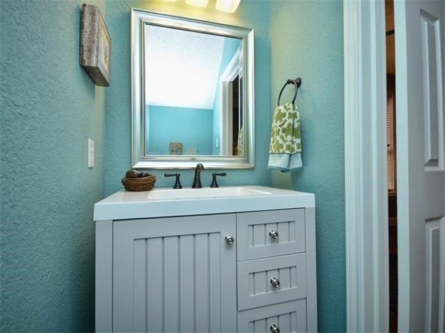7508 Windrush Drive Austin, TX 78729 - Photo 17 of 22 a bathroom with a sink and a mirror