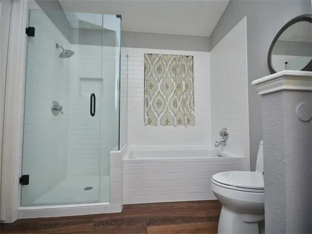 a bathroom with a toilet and a shower