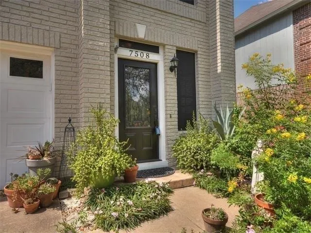 a couple of potted plants in front of door