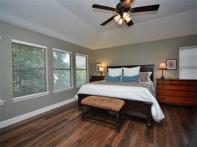 7508 Windrush Drive Austin, TX 78729 - Photo 22 of 22 a bedroom with a bed dresser and a window