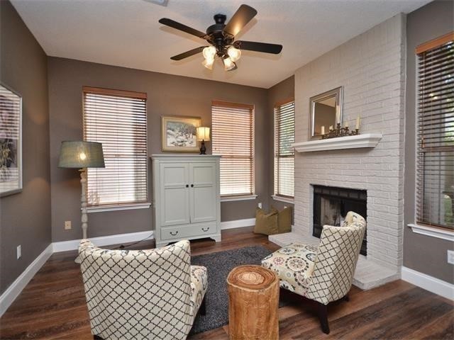7508 Windrush Drive Austin, TX 78729 - Photo 3 of 22 a living room with furniture and a fireplace