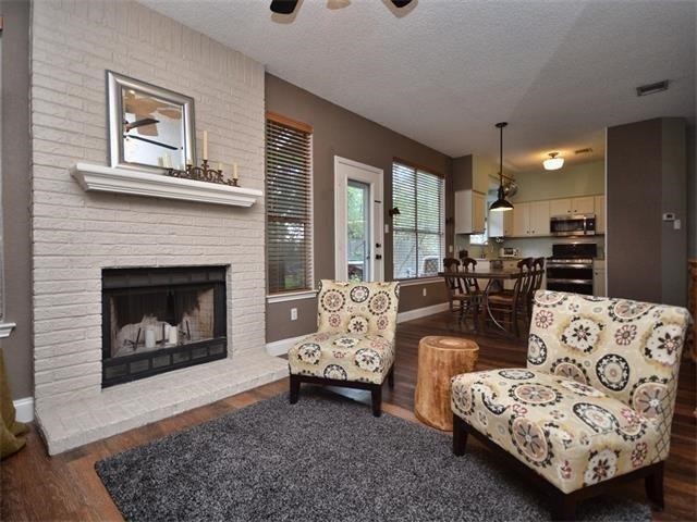 7508 Windrush Drive Austin, TX 78729 - Photo 4 of 22 a living room with furniture and a fireplace