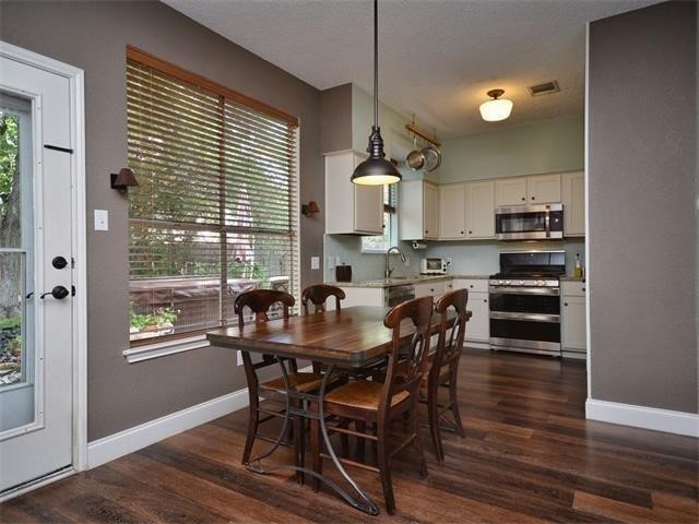 7508 Windrush Drive Austin, TX 78729 - Photo 5 of 22 a view of a dining room with furniture and wooden floor