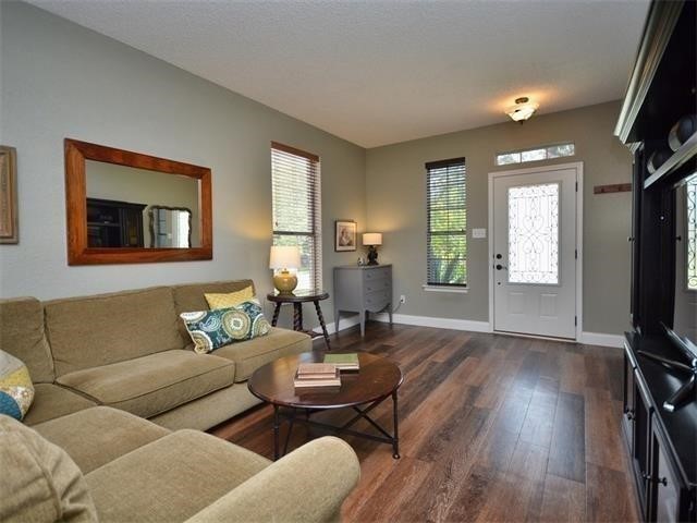 7508 Windrush Drive Austin, TX 78729 - Photo 6 of 22 a living room with furniture and a flat screen tv