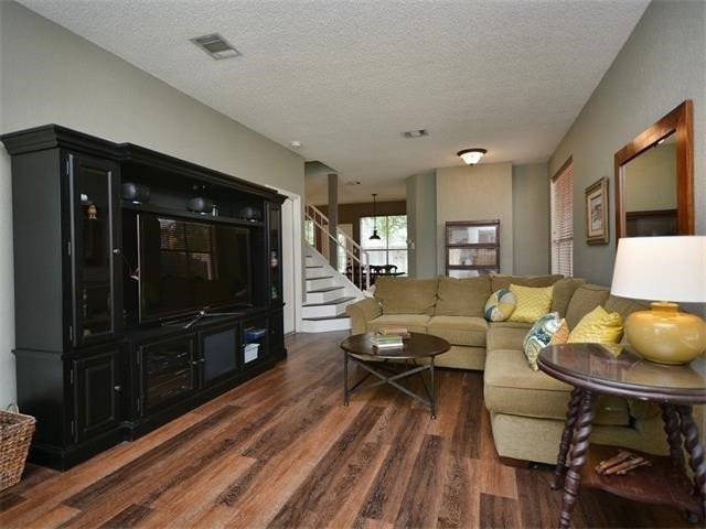 7508 Windrush Drive Austin, TX 78729 - Photo 7 of 22 a living room with furniture and a flat screen tv