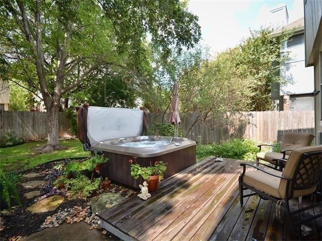 7508 Windrush Drive Austin, TX 78729 - Photo 10 of 22 a view of a backyard with table and chairs and a barbeque