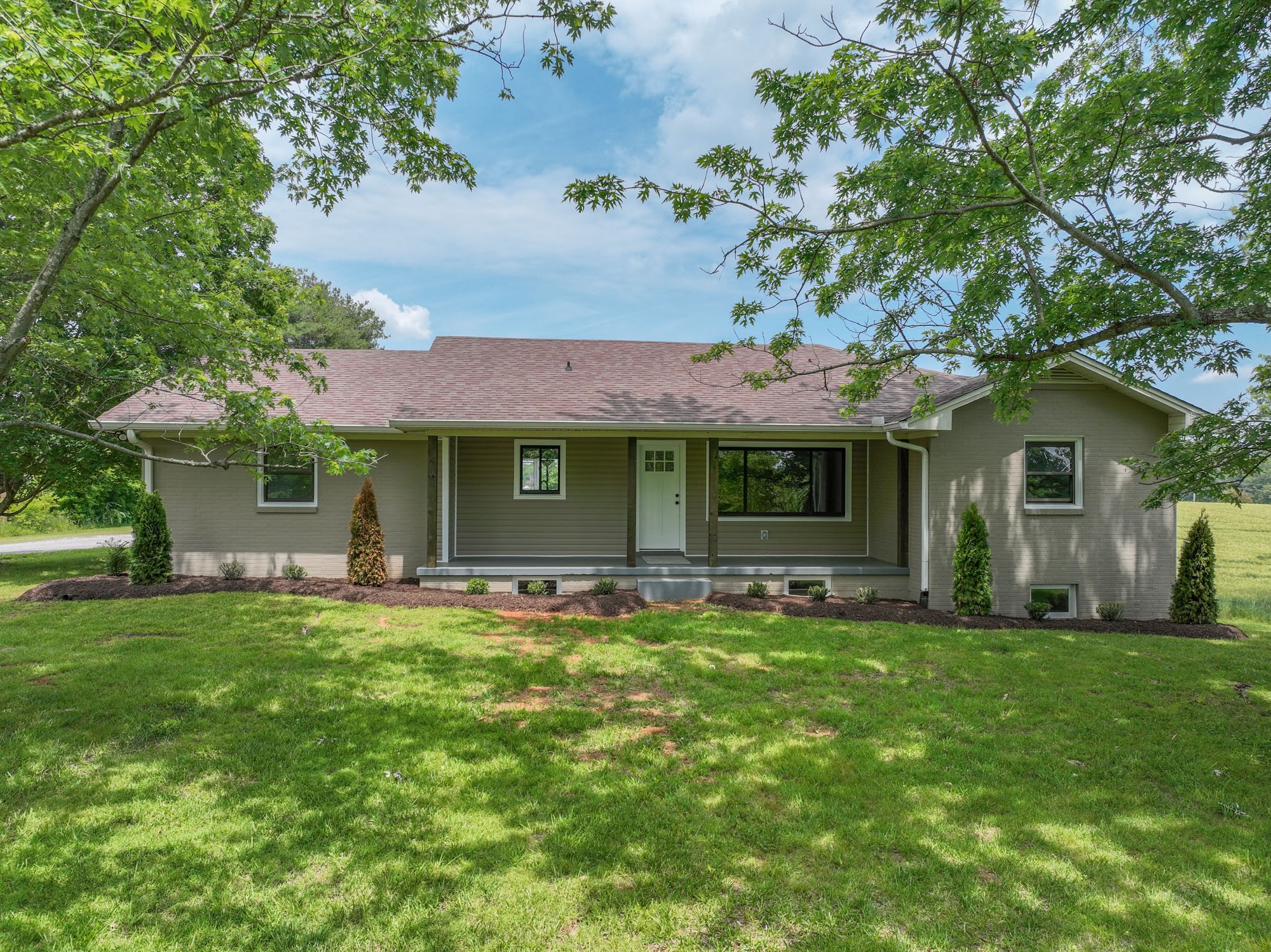 4334 Mt Zion Road Springfield, TN 37172 - Photo 1 of 52 a front view of a house with a garden and trees
