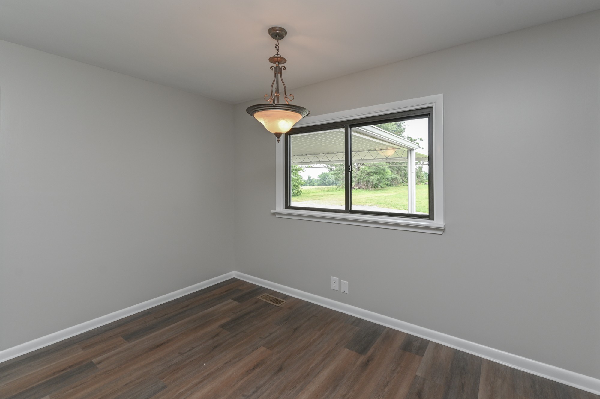 4334 Mt Zion Road Springfield, TN 37172 - Photo 12 of 52 a view of an empty room with wooden floor and a window