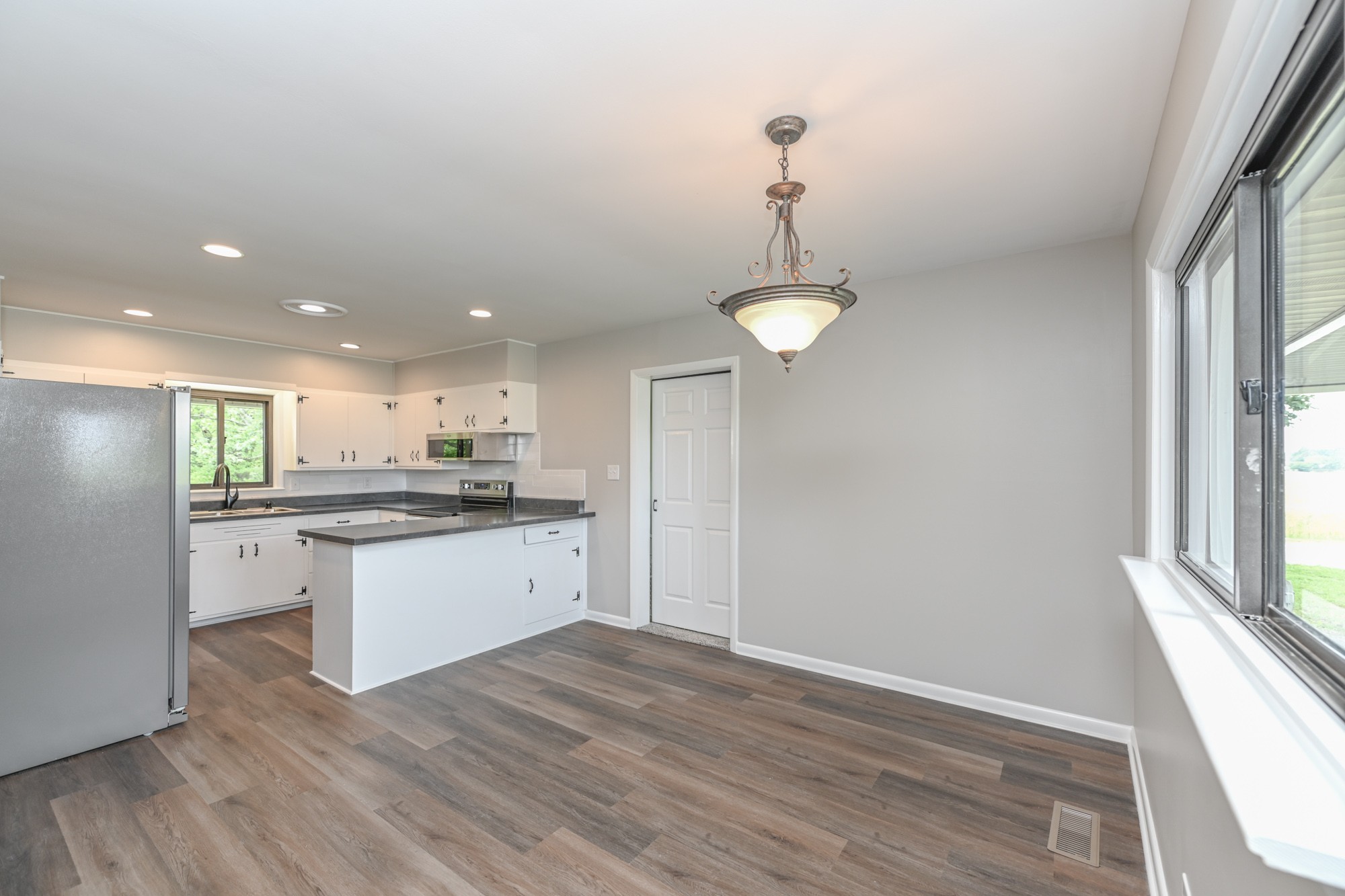 4334 Mt Zion Road Springfield, TN 37172 - Photo 13 of 52 a kitchen with stainless steel appliances granite countertop a sink cabinets and wooden floor