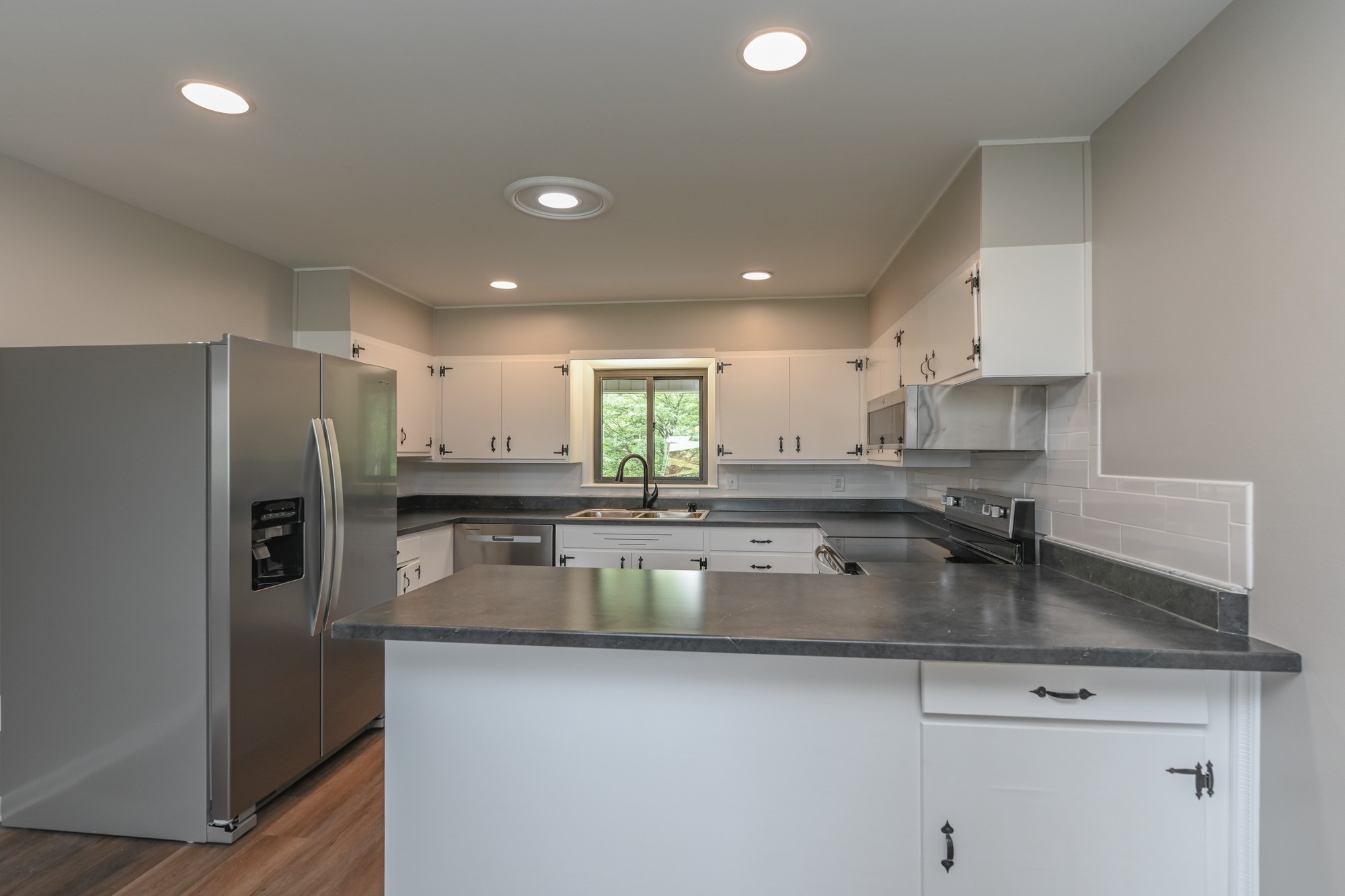 4334 Mt Zion Road Springfield, TN 37172 - Photo 14 of 52 a kitchen with stainless steel appliances granite countertop a sink a stove and a refrigerator
