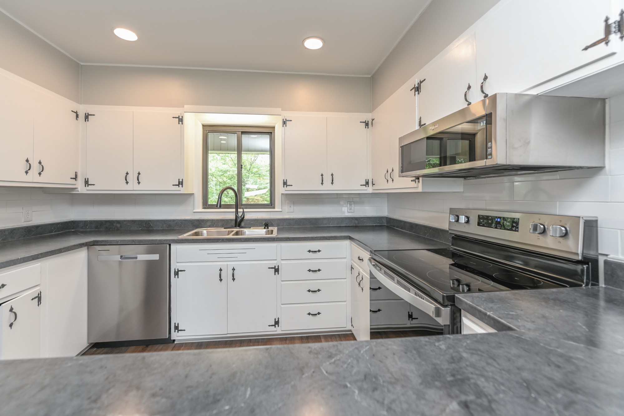4334 Mt Zion Road Springfield, TN 37172 - Photo 16 of 52 a kitchen with stainless steel appliances granite countertop a sink and cabinets with wooden floors
