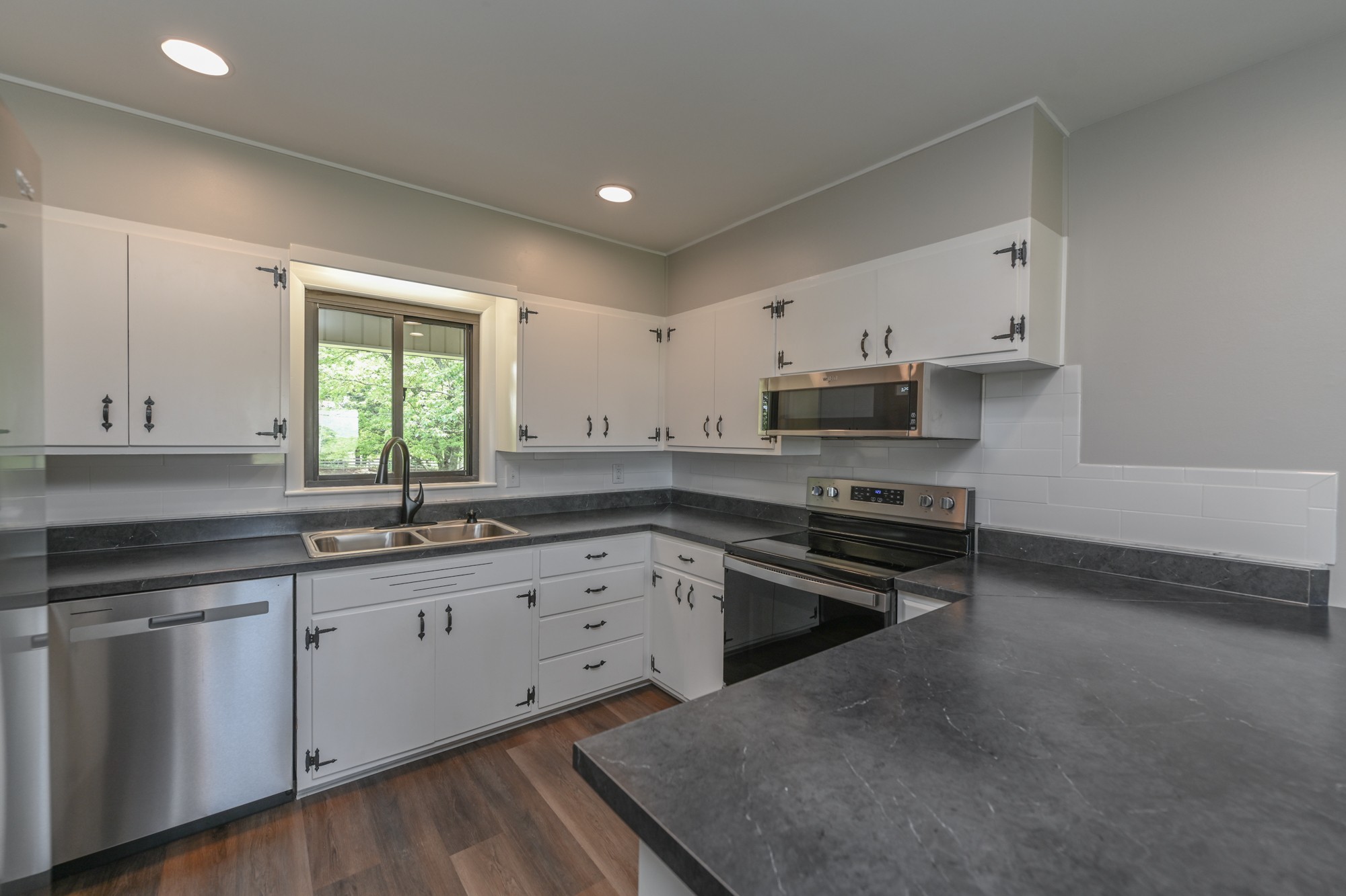 4334 Mt Zion Road Springfield, TN 37172 - Photo 17 of 52 a kitchen with stainless steel appliances granite countertop a stove a sink and a microwave