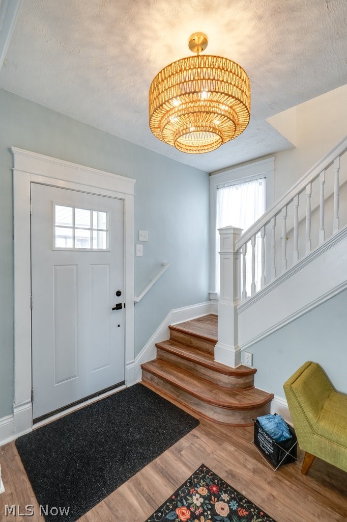 12 South 4th Street Rittman, OH 44270 - Photo 6 of 48 Entrance foyer with wood finished floors and a textured ceiling